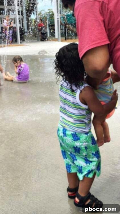 Olivia in CYBEX Balios M stroller observing water park fun