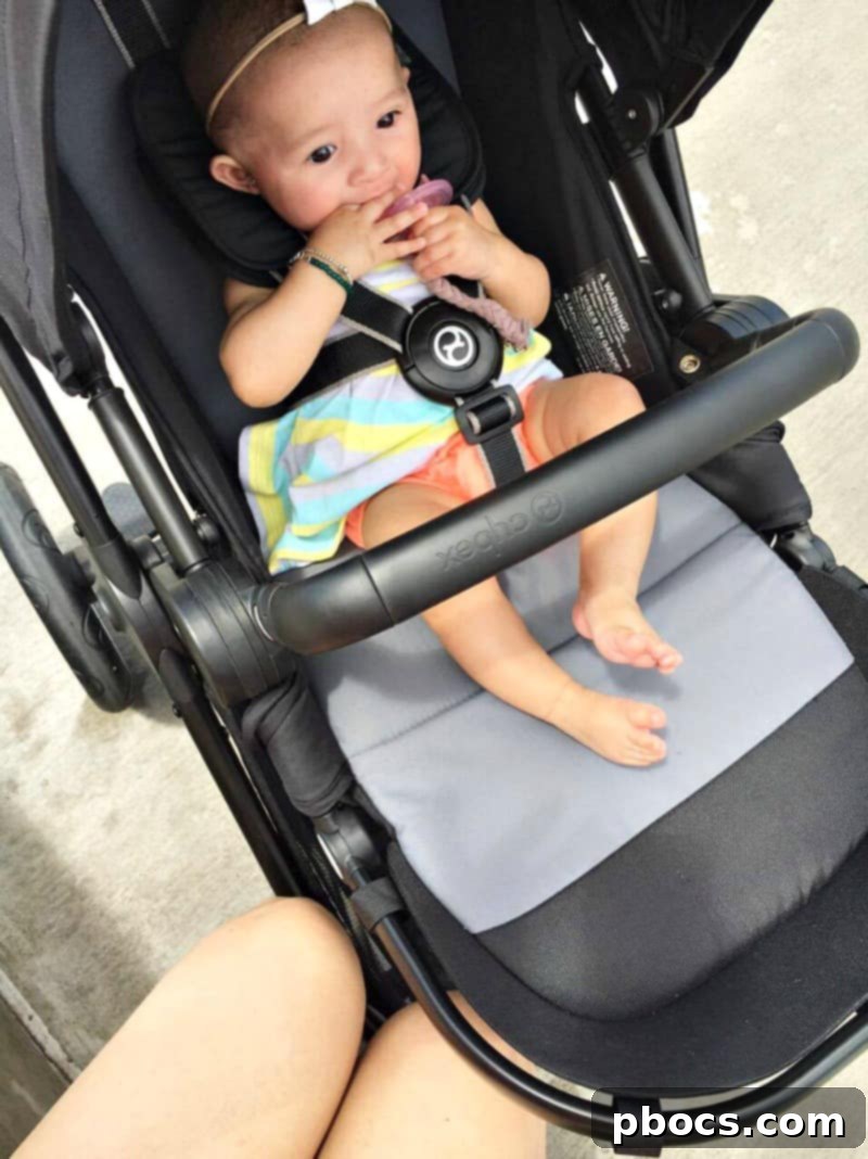 Children playing at the water park with a stroller nearby