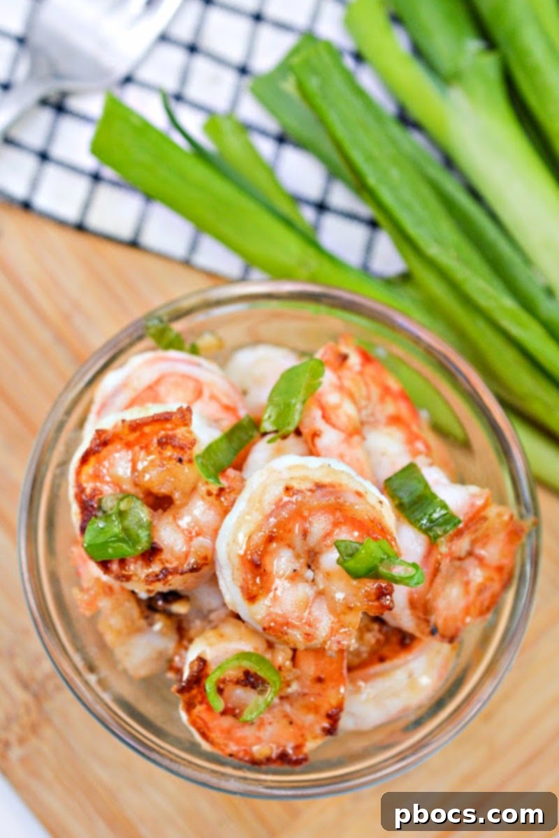 Sticky Honey-Garlic Keto Shrimp 7 Plated Keto Honey Garlic Butter Shrimp with a side of green onions