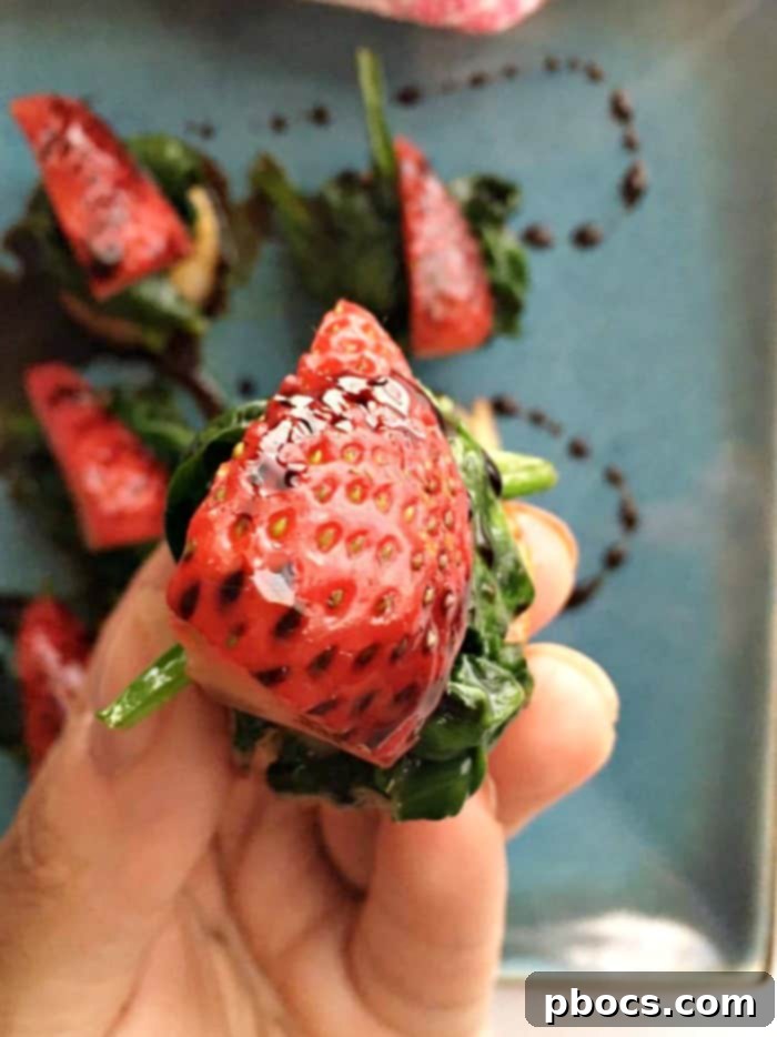 A top-down view of the Scallops, Spinach & Strawberries With Balsamic Syrup dish, showcasing the artful arrangement of ingredients.