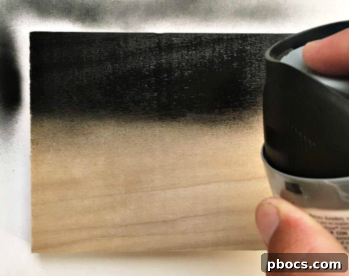 DIY Chalkboard Backpack Organizer 8 Applying chalkboard spray paint to a piece of wood for the backpack rack