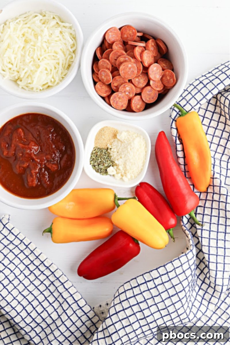 Mini Bell Peppers sliced in half and arranged on a baking sheet, ready to be filled