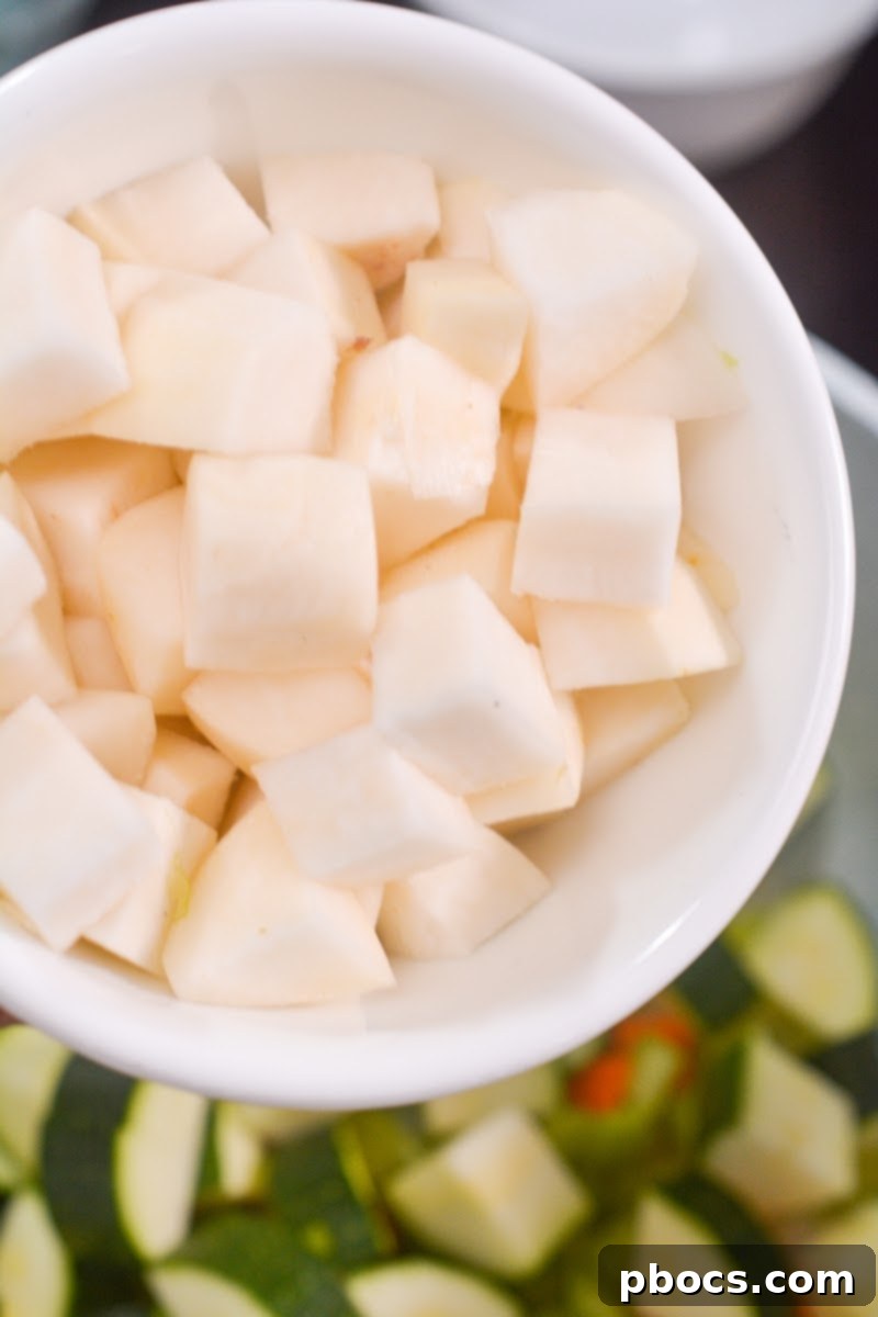 Vegetables being added to melted butter in a pot