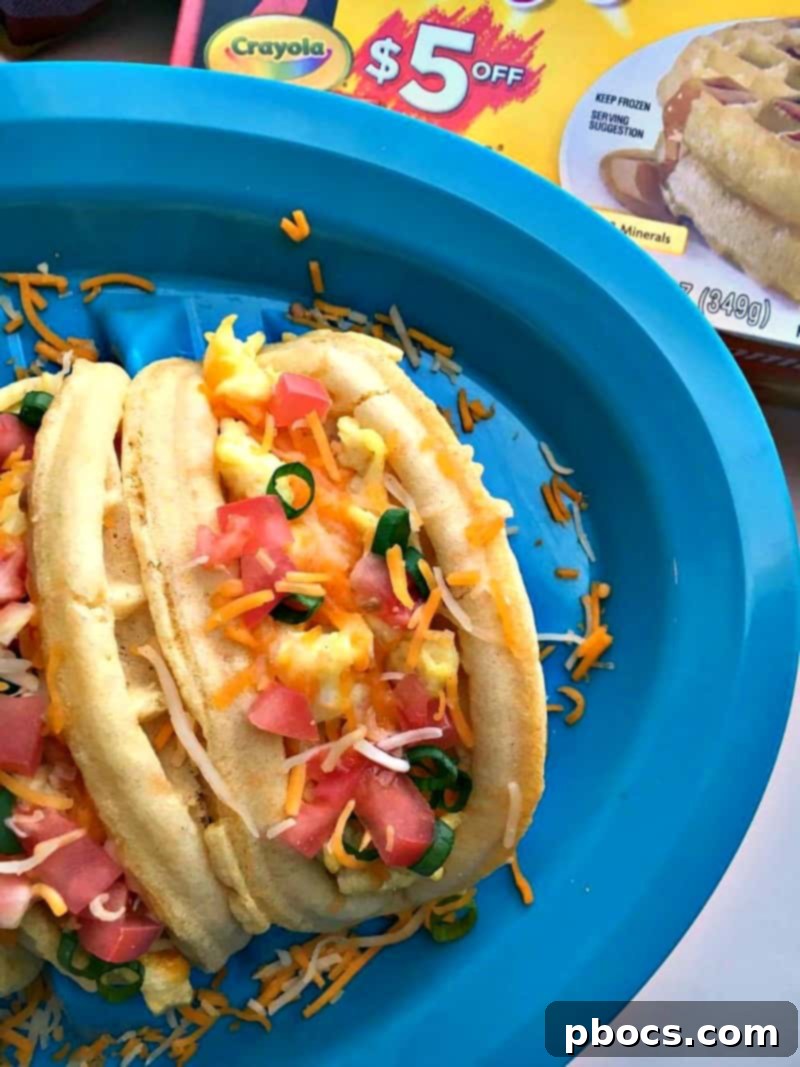 Eggo Waffle Tacos topped with cheese, tomatoes, and green onions