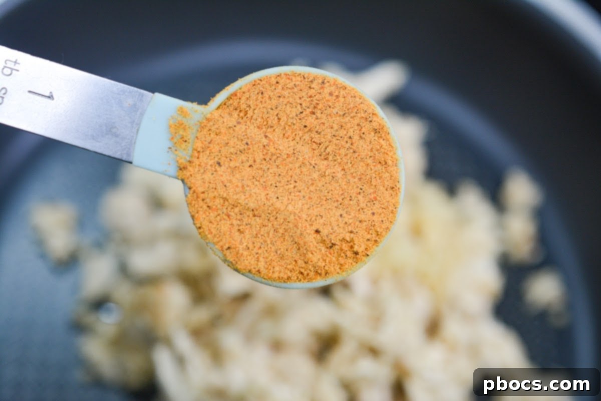 Mixing chicken filling with cream cheese and jalapenos