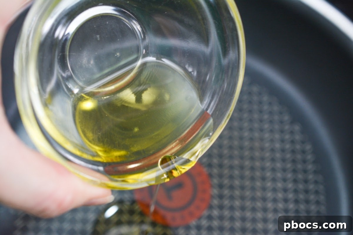 Heating olive oil in a skillet for chicken filling