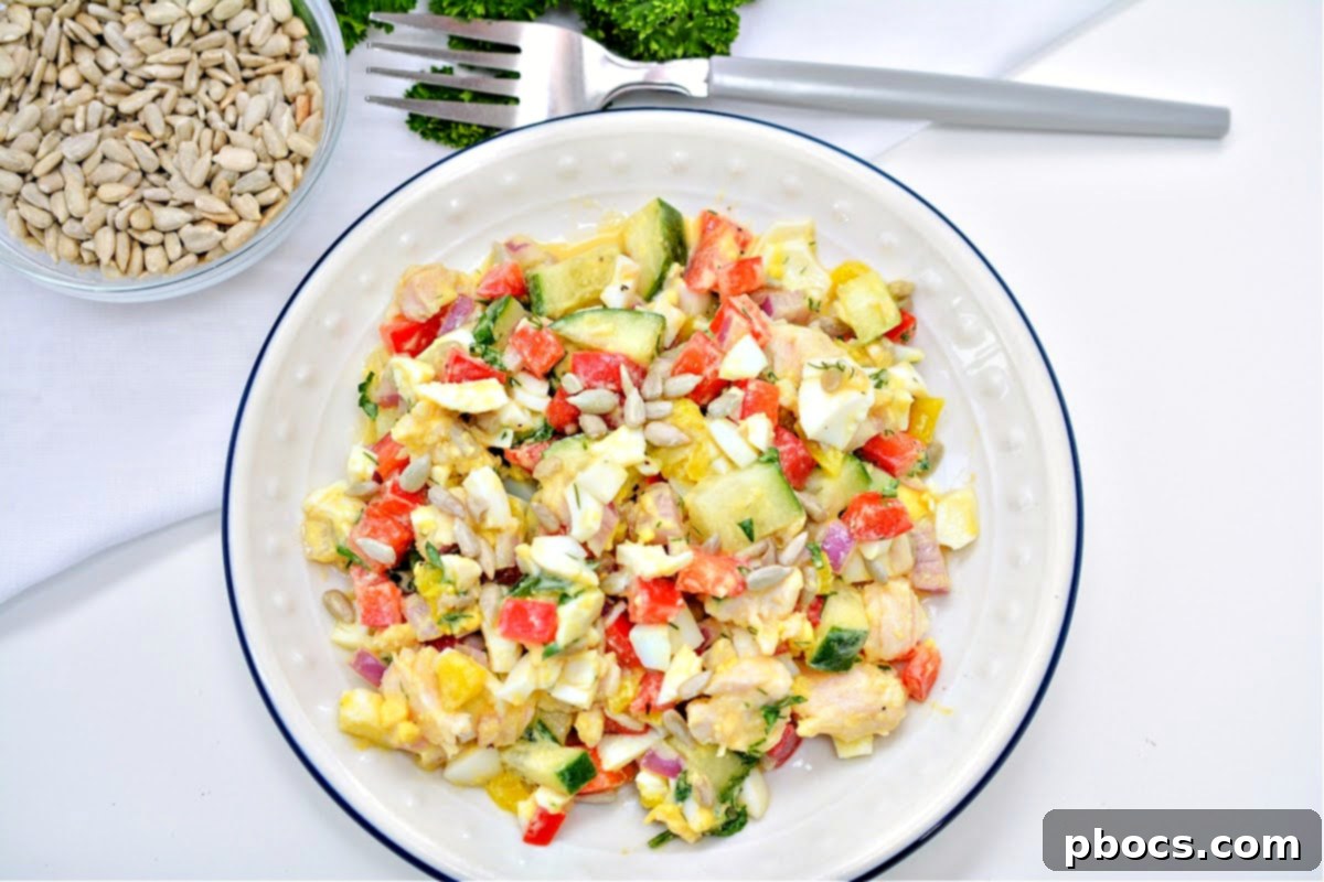 Close-up of Keto TikTok Hot Girl Summer Chicken Salad with crunchy sunflower seeds and red onions