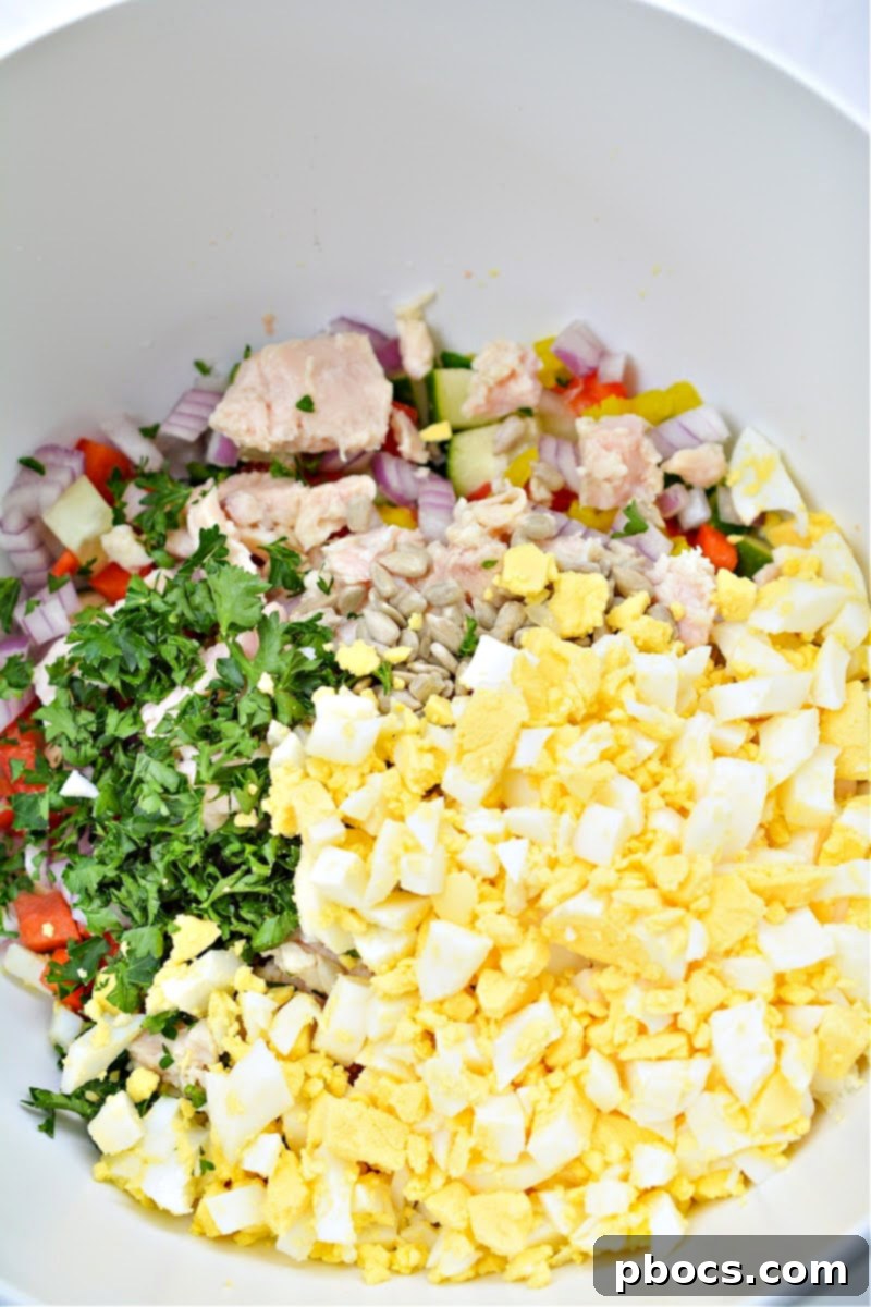 Mixing salad ingredients for Keto TikTok Hot Girl Summer Chicken Salad