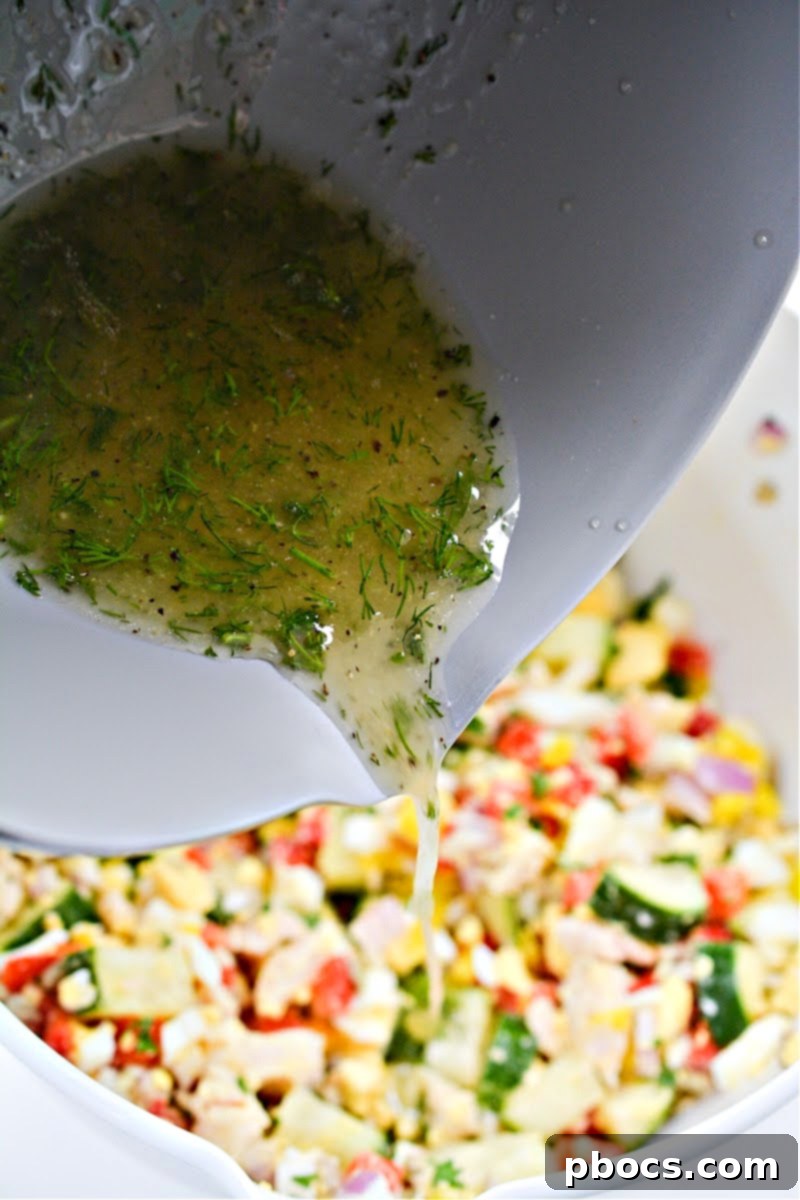 Pouring dressing over Keto TikTok Hot Girl Summer Chicken Salad