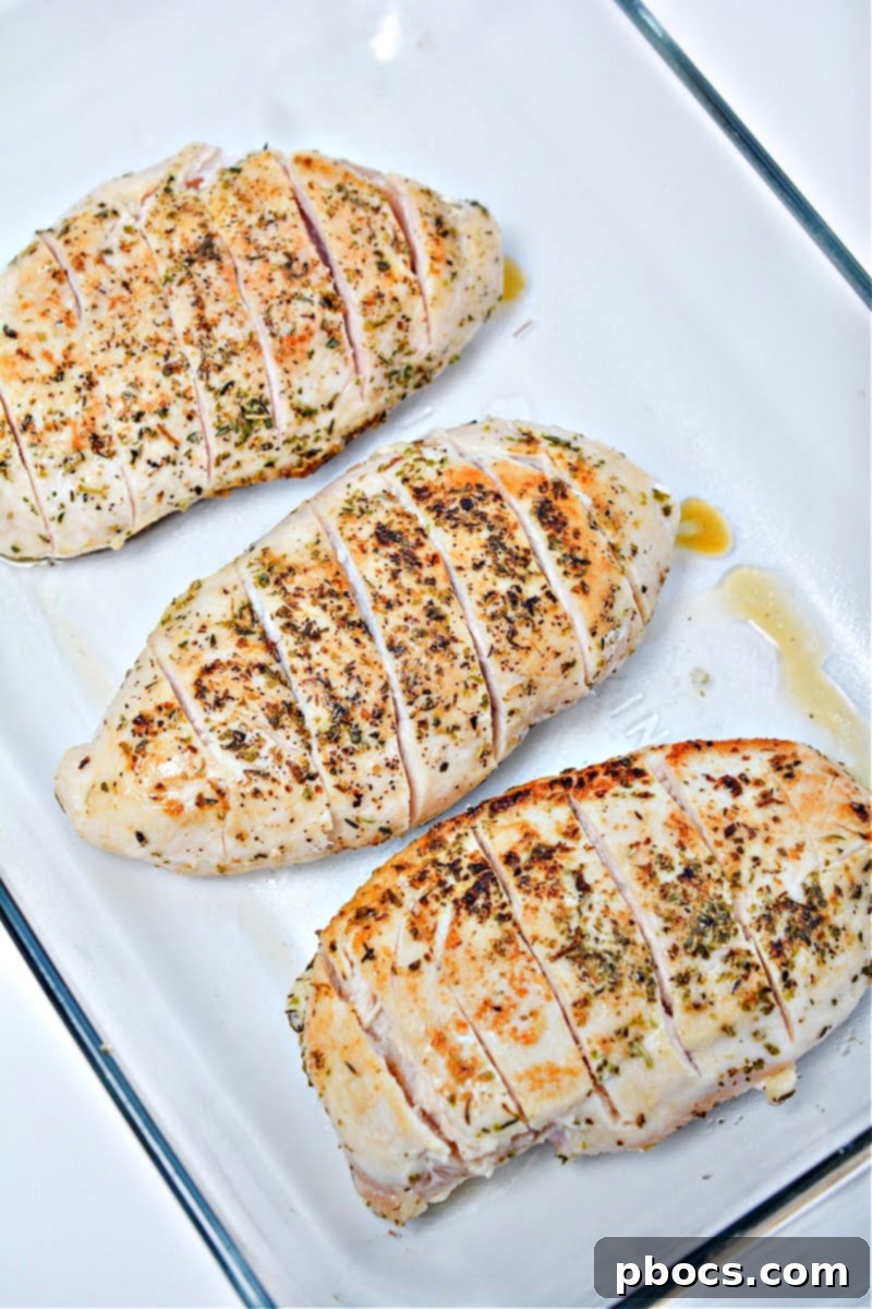 Antipasto-Loaded Keto Hasselback Chicken 11 Placing seared chicken into a baking dish