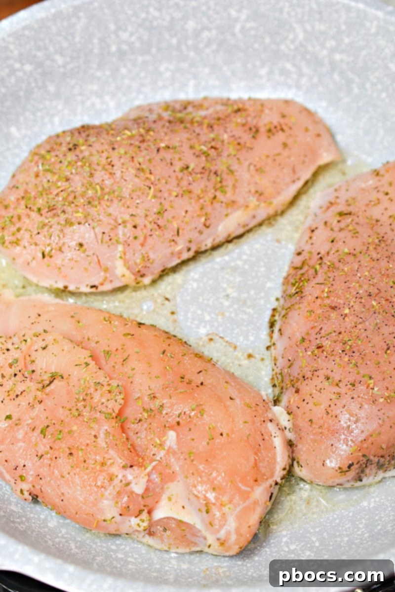 Antipasto-Loaded Keto Hasselback Chicken 9 Seasoning the chicken breasts with Italian herbs