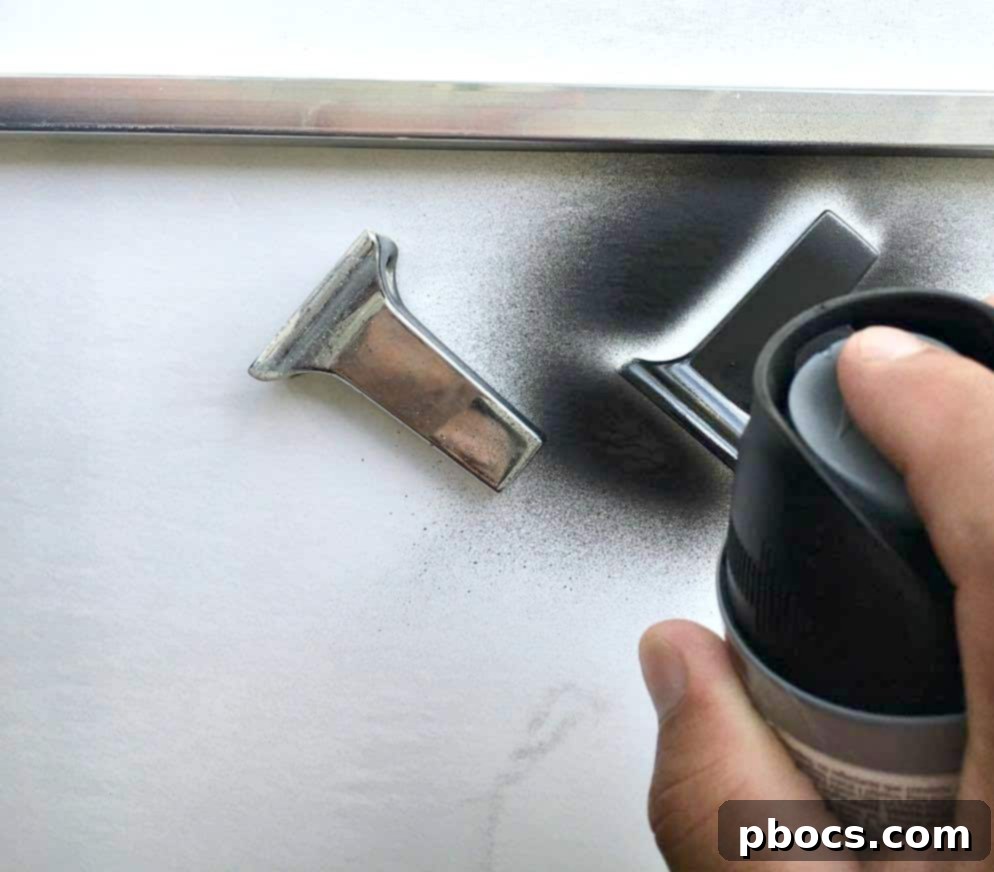 Towel bar being spray painted black