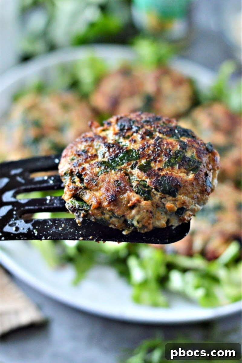 Grilled Keto Spinach Feta Turkey Burgers cooking on a skillet