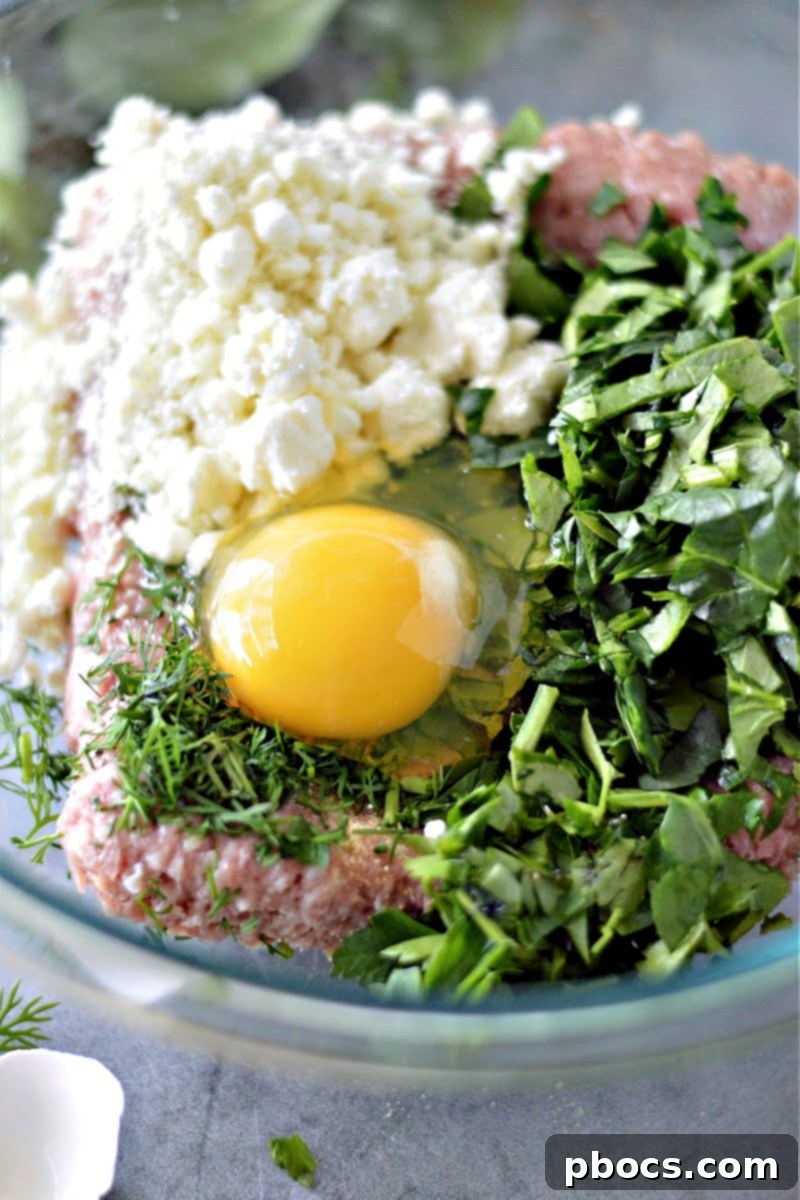 Combining ingredients for Keto Spinach Feta Turkey Burgers in a bowl