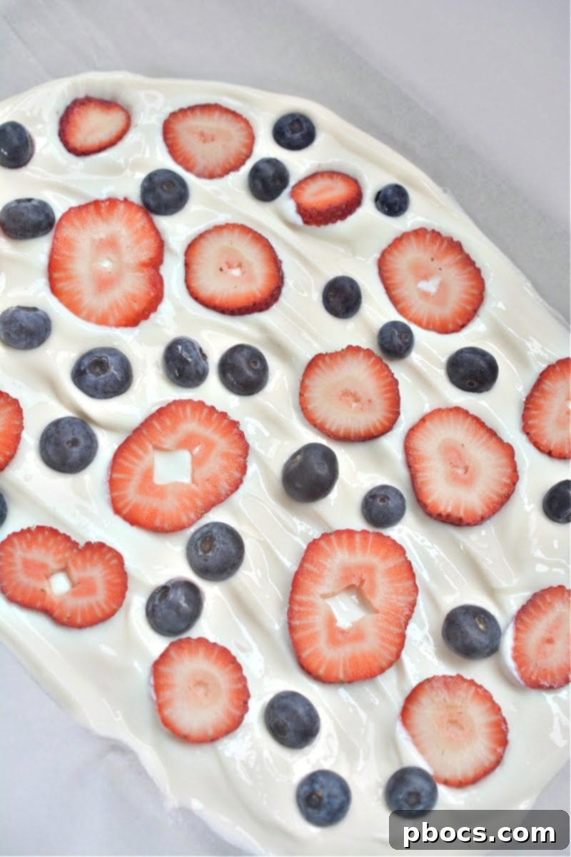 Sprinkling sunflower seeds and almonds on yogurt bark