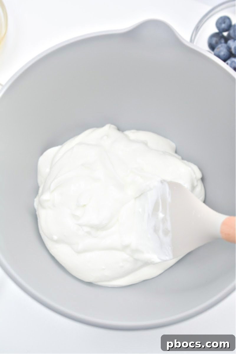 Mixing Greek yogurt with sugar-free honey and vanilla extract