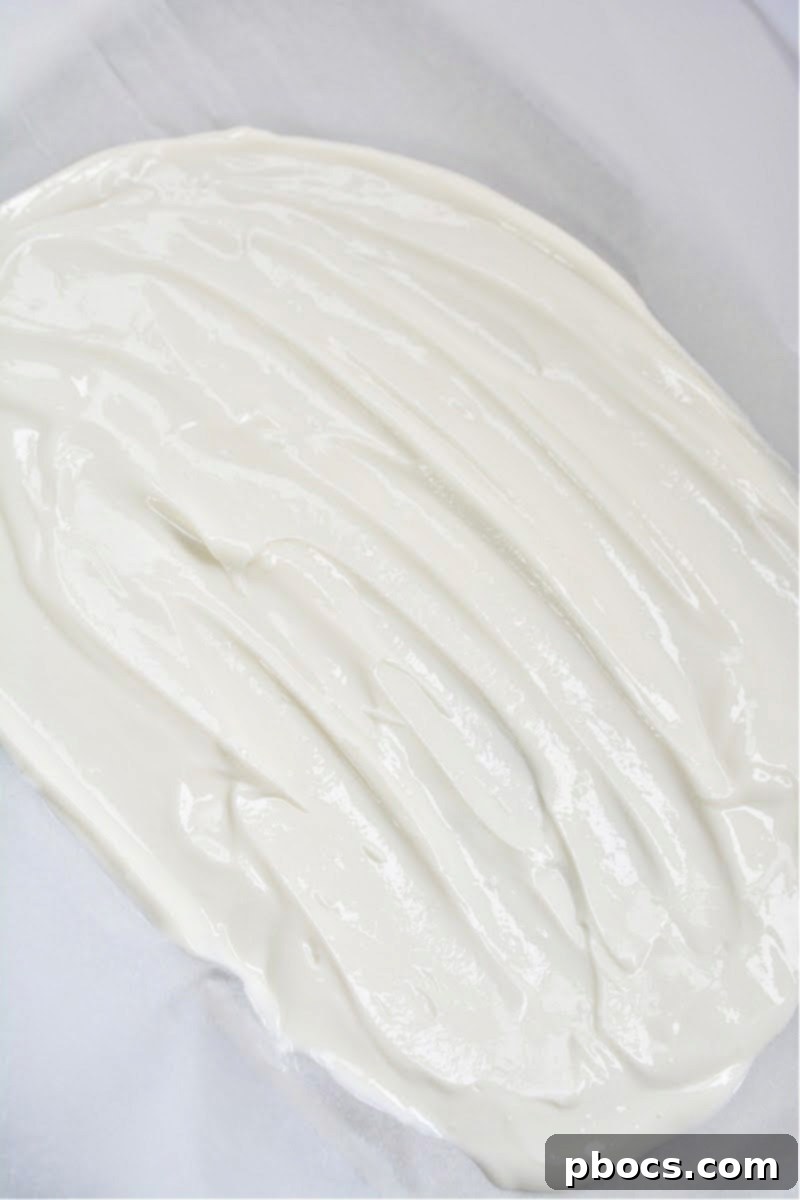 Layering strawberry slices and blueberries over yogurt