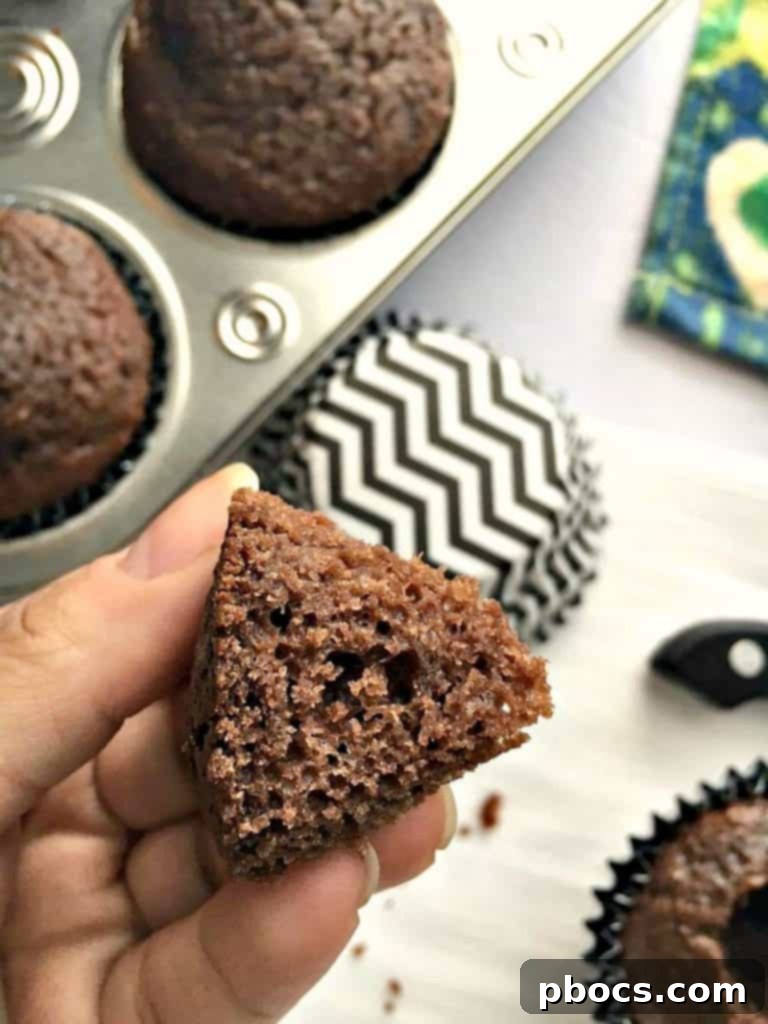 Using a knife to cut a circular hole in the center of a baked cupcake