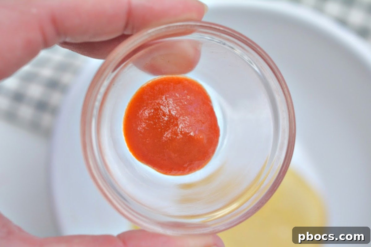 Sriracha sauce in a small ceramic bowl, ready to be mixed for the sauce