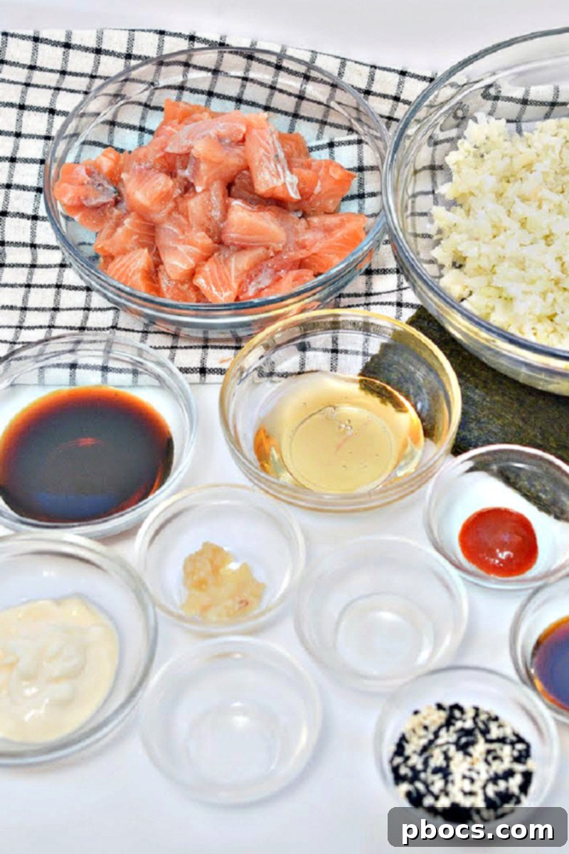 Collection of fresh ingredients for Keto TikTok Salmon Sushi Nori Cups including salmon, nori, rice vinegar, and sauces