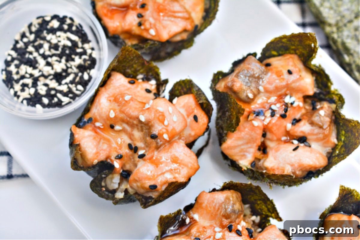 Close-up of baked Salmon Sushi Nori Cups garnished with sesame seeds, showing their appetizing texture