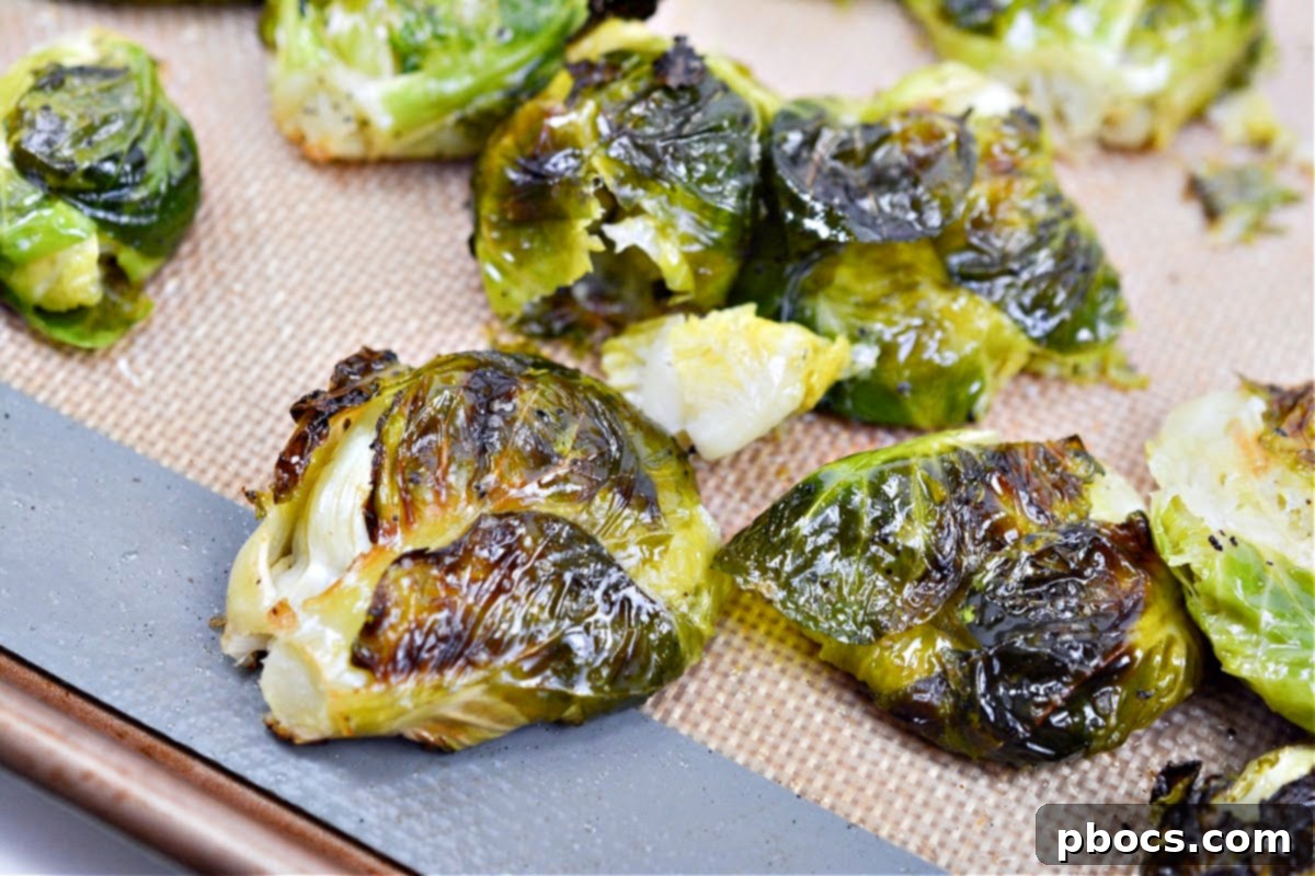 Roasted Brussels sprouts on a baking sheet, showing their beautifully browned and tender appearance after cooking.