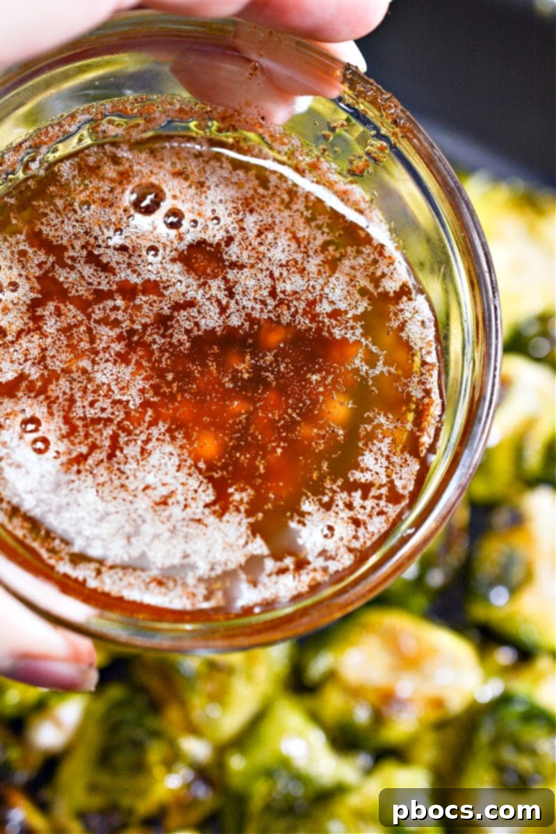 A small bowl containing red pepper flakes and bacon pieces, ready to be used as a garnish for the smashed Brussels sprouts.