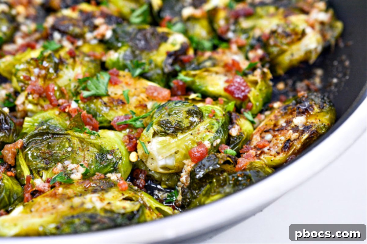 A closer view of Keto Smashed Brown Butter Brussels Sprouts in a serving dish, highlighting the browned butter and crispy texture.