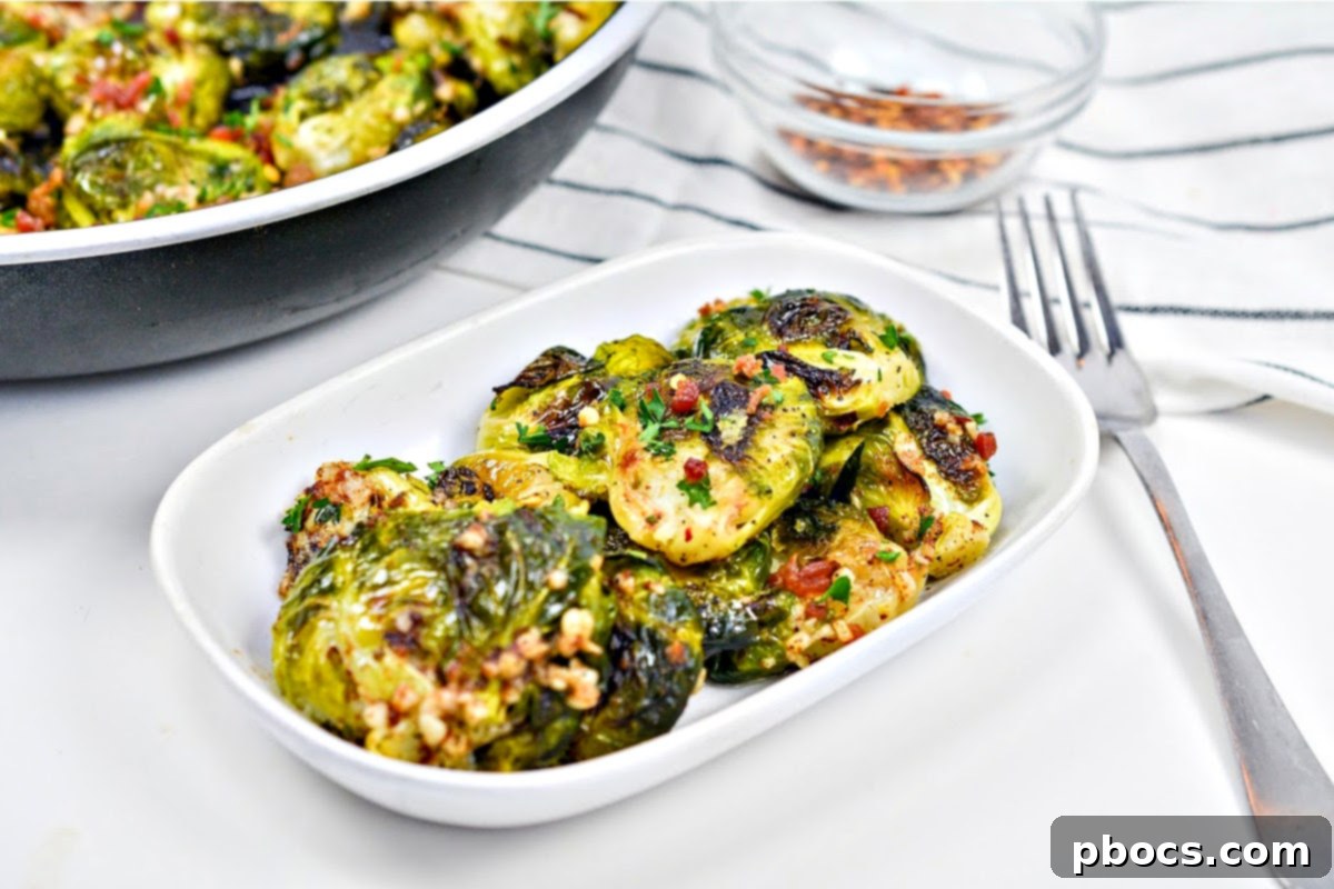 A generous serving of Keto Smashed Brown Butter Brussels Sprouts on a plate, showcasing a close-up of the dish's appealing texture.