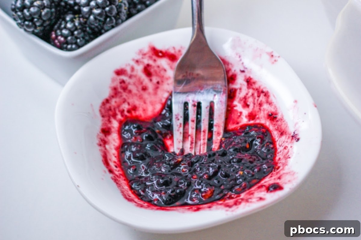 Smashing Blackberries in a small bowl