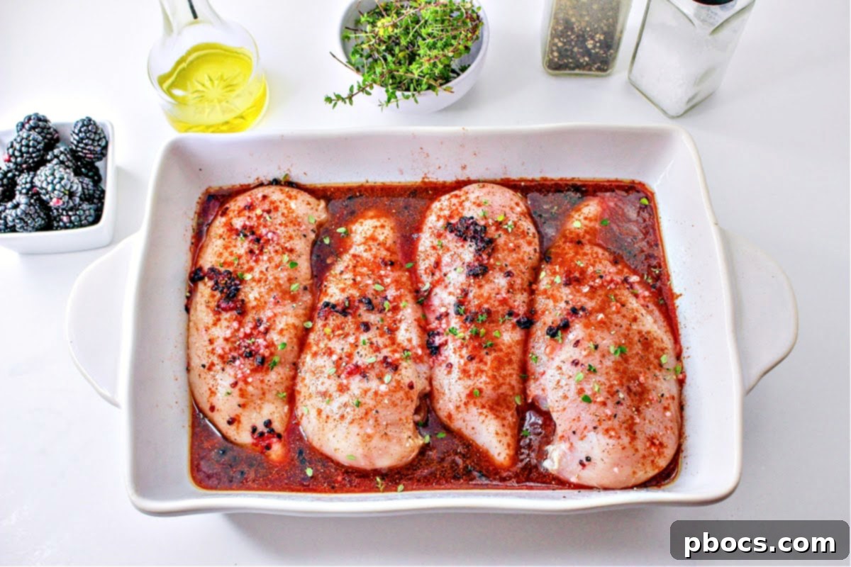 Seasoned chicken breasts in a casserole dish and ready for the oven