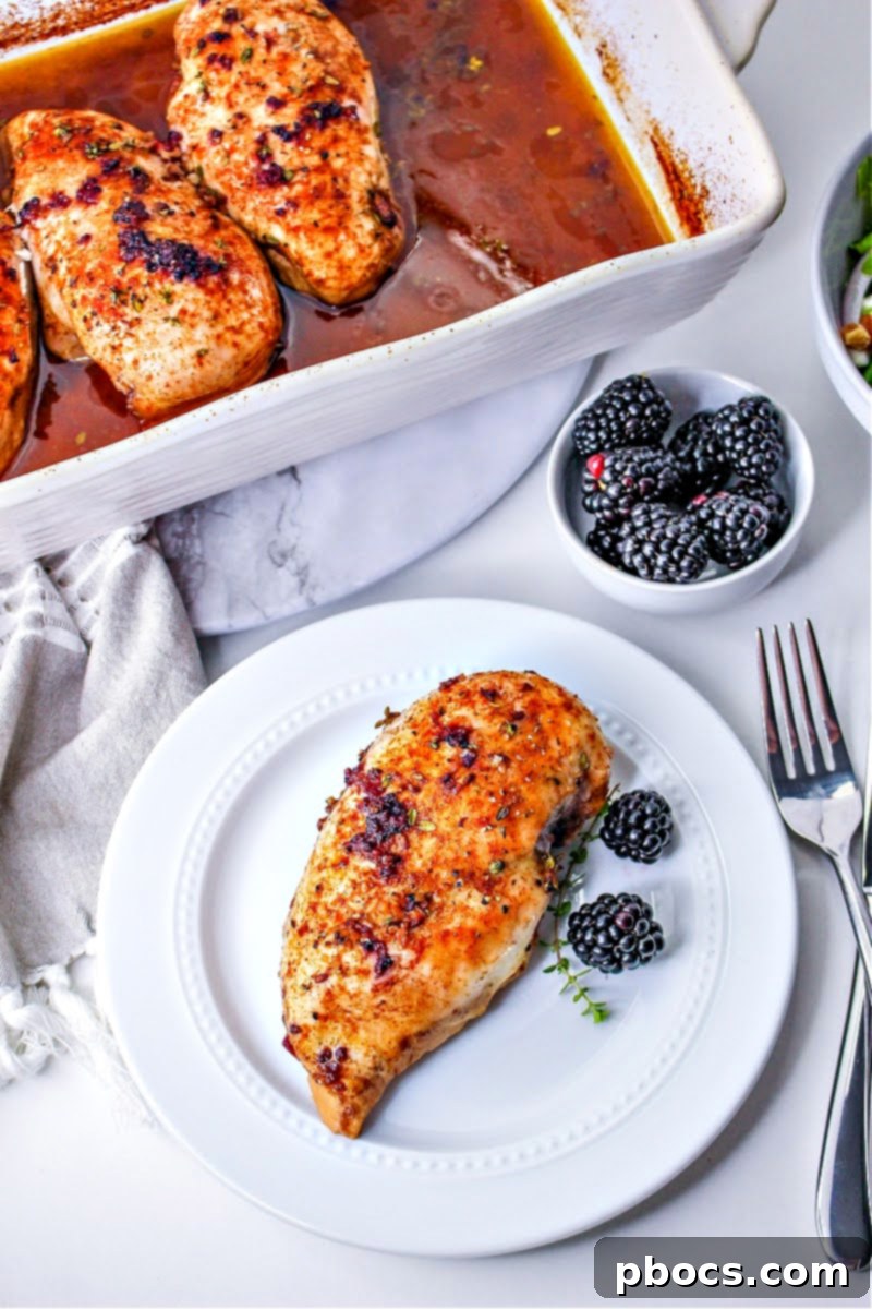 A casserole dish with blackberry chicken and a white plate holding one serving of blackberry chicken