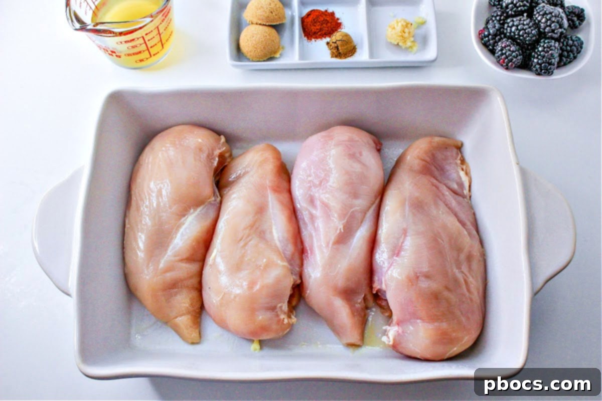 4 skinless, boneless chicken breasts in a white casserole dish