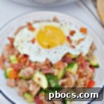 Keto Sausage Zucchini Breakfast Skillet 13 Keto Zucchini Breakfast Hash with an egg on top