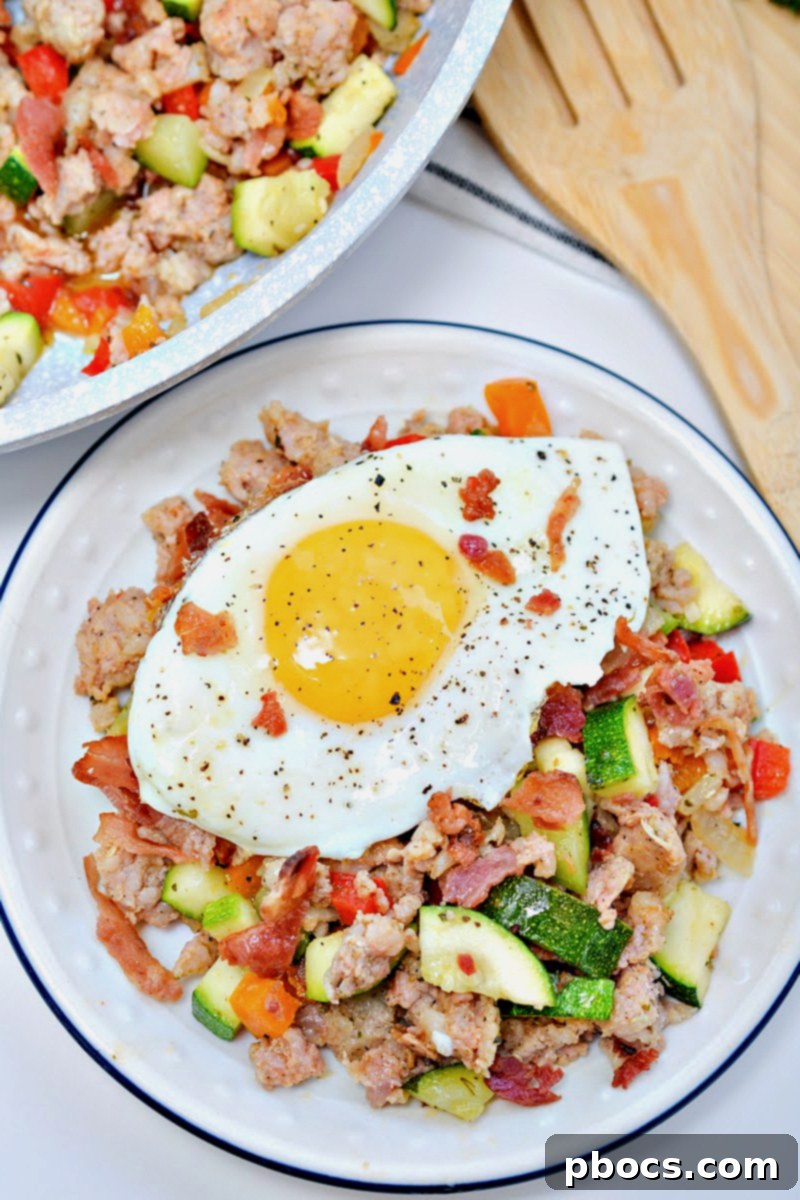 Keto Sausage Zucchini Breakfast Skillet 4 Overhead shot of a skillet filled with freshly cooked Keto Sausage and Zucchini Breakfast Hash, ready to be served.