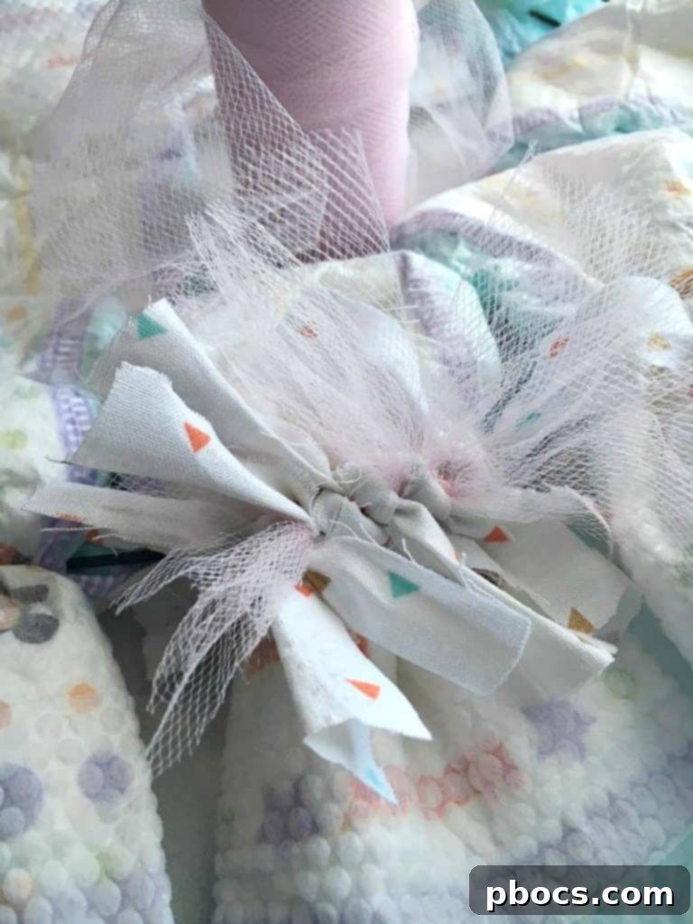Tying Fabric and Tulle Ribbon onto Diaper Wreath Base