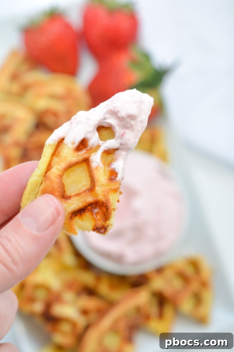Strawberry Shortcake Chaffle Dippers with Keto Cream Dream 2 A chaffle chip with strawberry dip on it