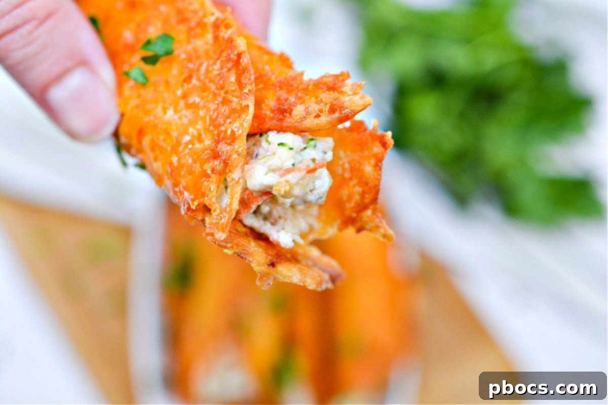 A close-up of a single Keto Ranch Cream Cheese Chicken and Veggies Roll Up, highlighting its delicious filling and cheese wrap.