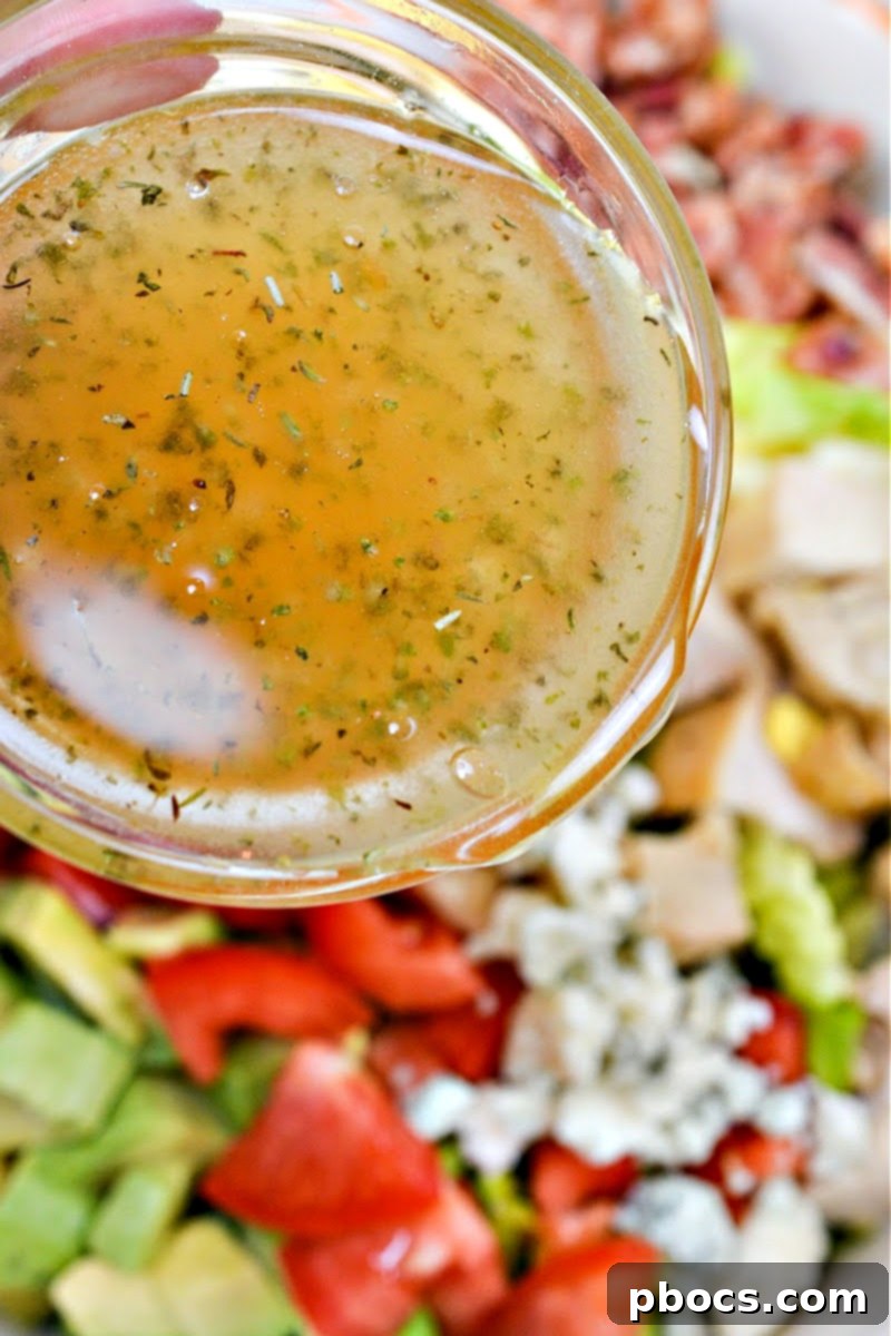 Adding vinaigrette to the salad
