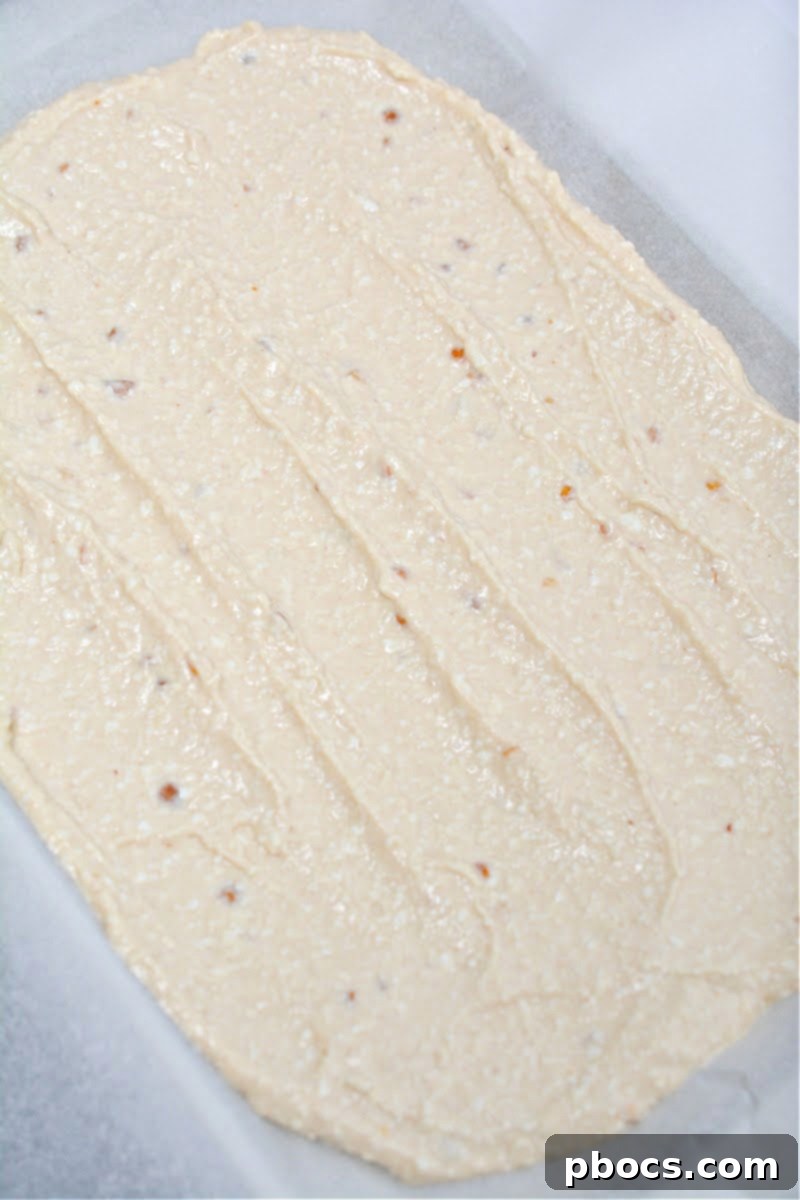 Keto Cottage Cheese Freezer Bark 11 Keto Frozen Cottage Cheese Bark mixture spread on a parchment-lined baking sheet