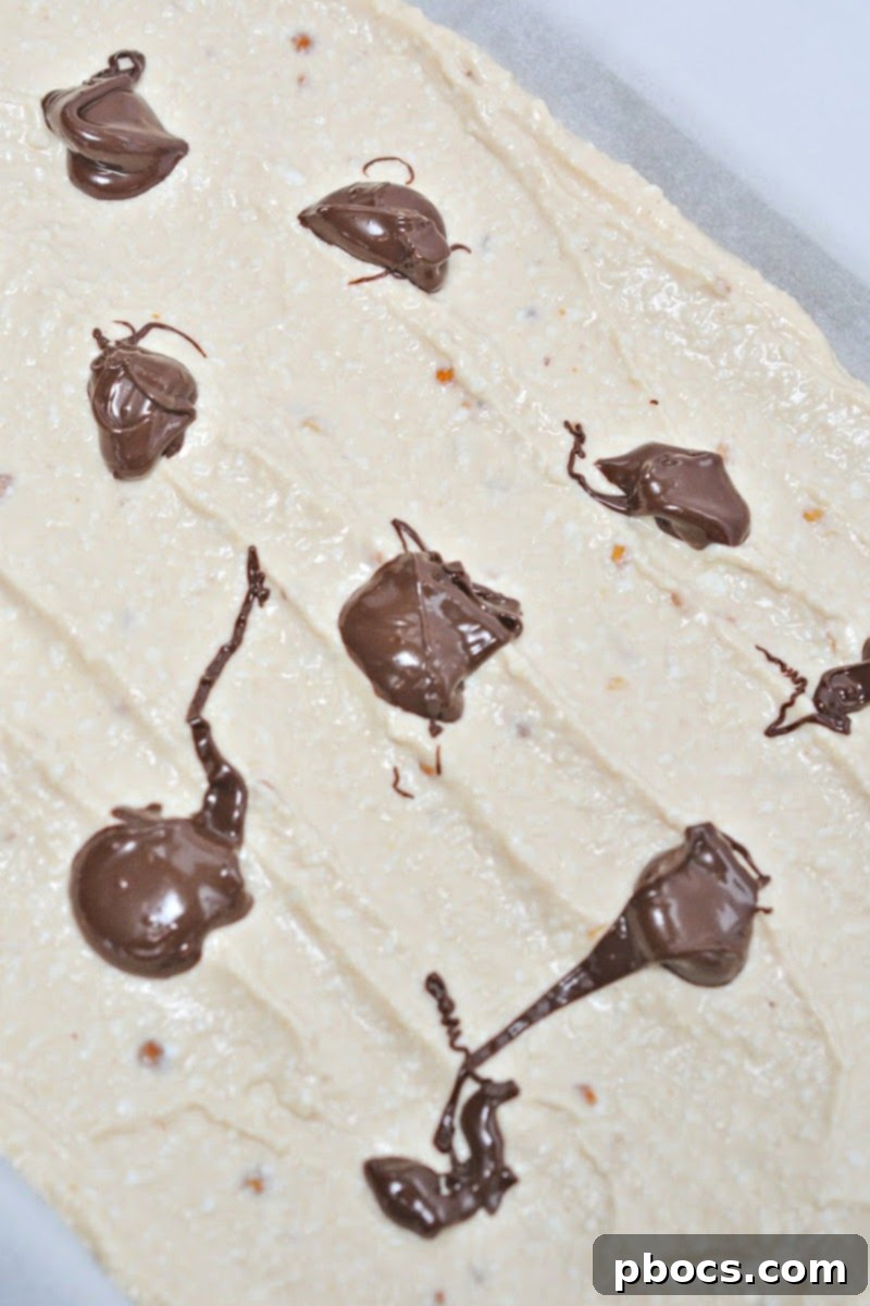 Keto Cottage Cheese Freezer Bark 12 Melted chocolate dollops on top of cottage cheese mixture