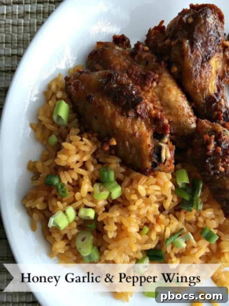 Delicious Honey Garlic Pepper Wings ready for serving on a platter, garnished with fresh herbs.