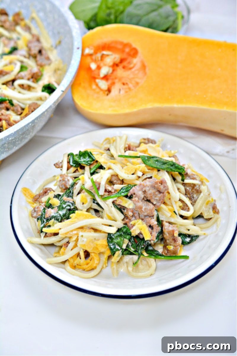 Closeup of Low-Carb Butternut Squash Palmini Noodles With Sausage, showing texture and ingredients.