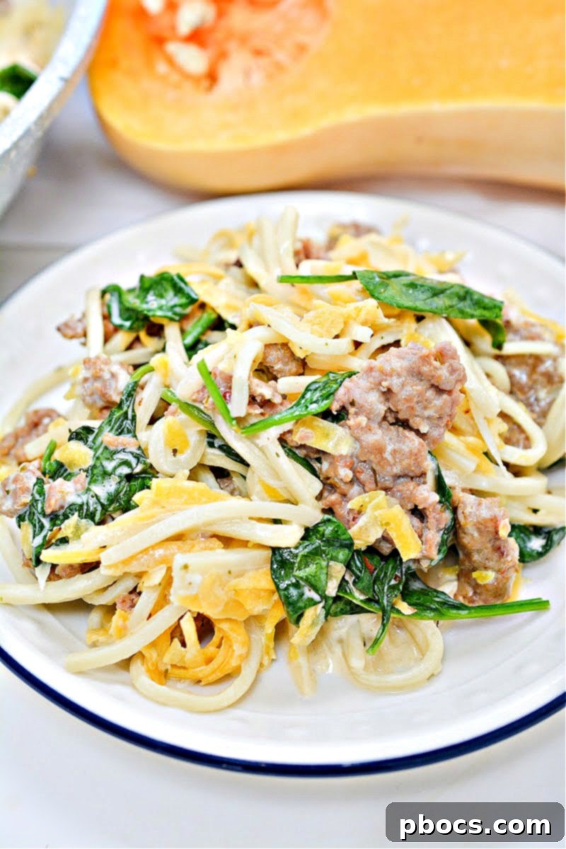 Close-up of Palmini linguini noodles being added to the butternut squash and sausage mixture.