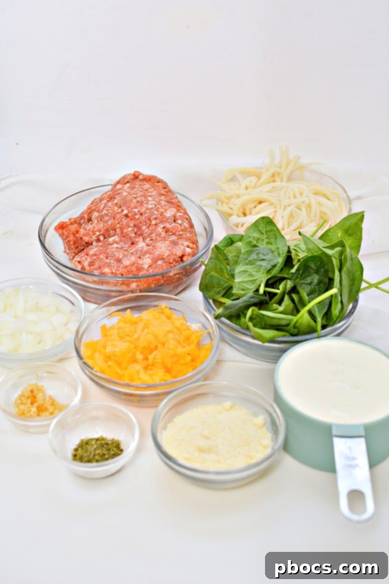 Arrangement of ingredients for Low-Carb Butternut Squash Palmini Noodles With Sausage on a wooden board.