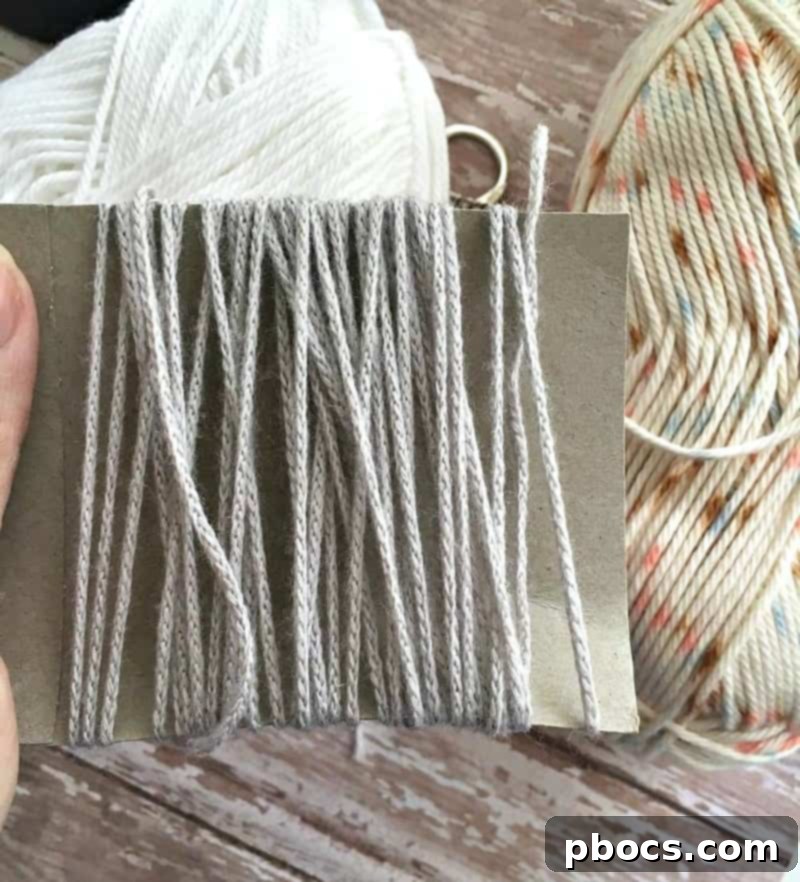 Crafting Adorable Pompom Keychains 7 DIY Pompom Keychain - Tying yarn center