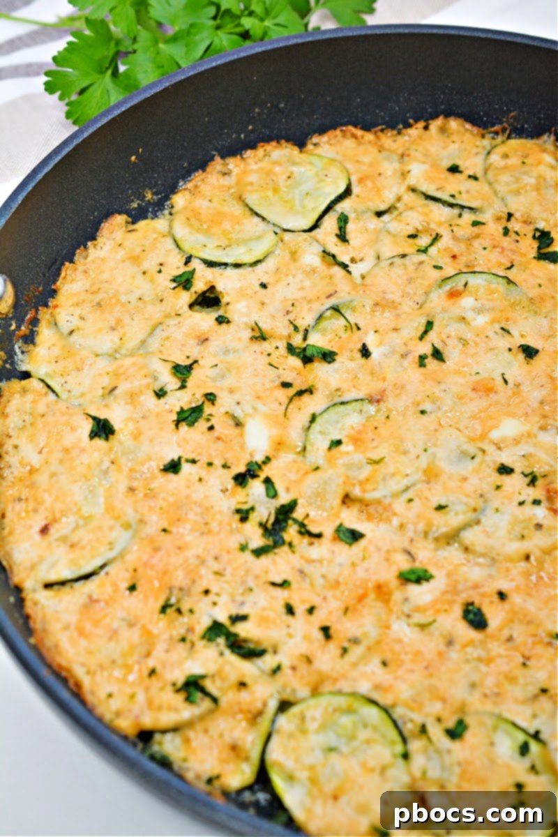 Freshly baked Keto Scalloped Zucchini in a skillet, golden brown and bubbly, ready to serve.