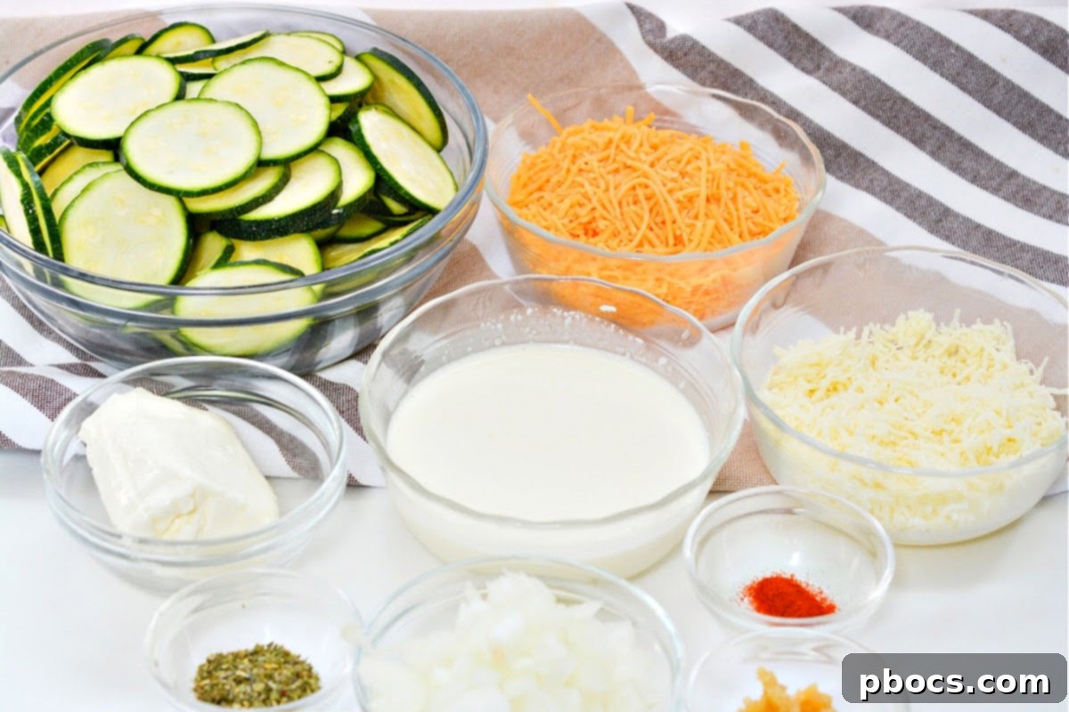 Keto Scalloped Zucchini Ingredients laid out on a counter, including zucchini, cheese, cream cheese, heavy cream, and spices.