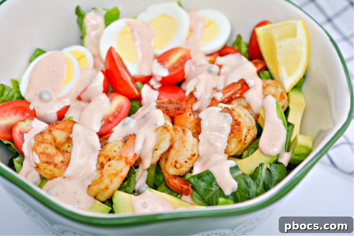 Drizzling homemade dressing over the Low-Carb Shrimp Louie Salad.