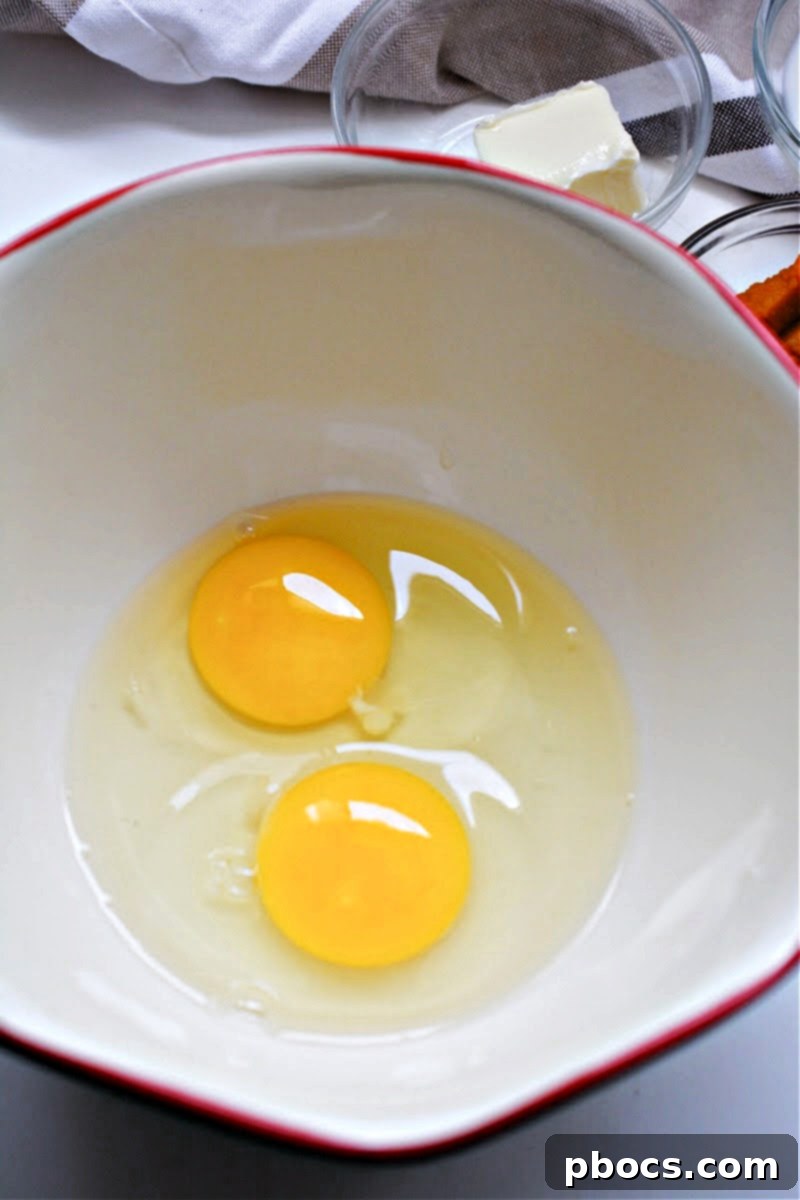 Eggs whisked with cream and spices in a bowl
